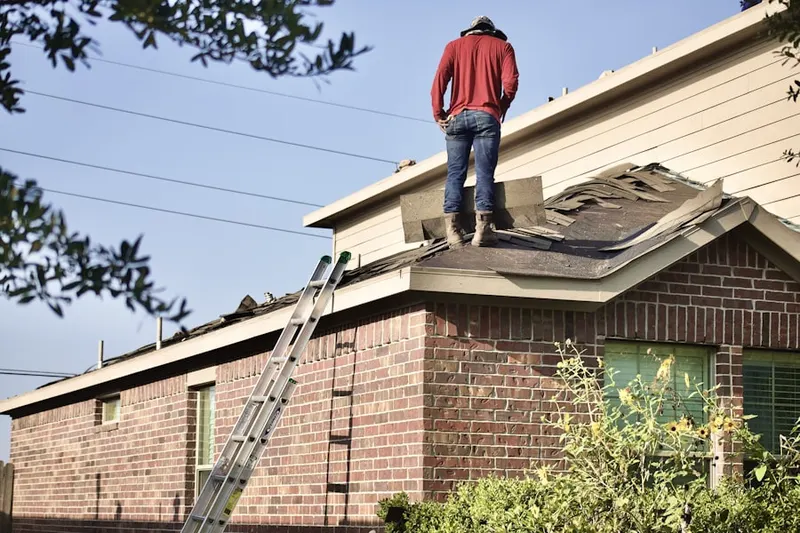Professional roofer working on a residential roof in Cooper